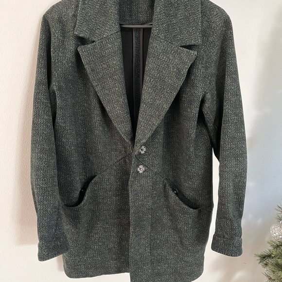 This is a lululemon cocoon coat in the color green with specs of black. - Picture 3 of 7